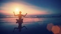 Silhouette of woman practicing yoga with the reflection on the wet sand. Royalty Free Stock Photo