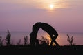 Silhouette of the woman practicing yoga