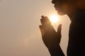 Silhouette of woman prayer position, Praying hands with faith in religion and belief in God on dark background. Power of hope or Royalty Free Stock Photo