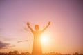 Silhouette of woman praying over beautiful sky background