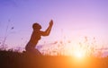 Silhouette of woman praying over beautiful sky background Royalty Free Stock Photo