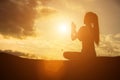 Silhouette of woman praying over beautiful sky background Royalty Free Stock Photo