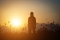 Silhouette of woman praying over beautiful sky