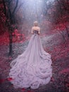 Silhouette woman queen in Autumn forest magic trees red leaves. blonde princess