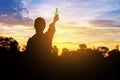 Silhouette woman raised hands holding a bottle on the sky, Royalty Free Stock Photo