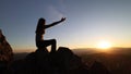 Silhouette of a woman raising her hands while the sun is rising for worshiping god. Struggle. Victory. praise to god spiritually