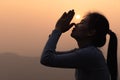 Silhouette of Woman raising his hands in worship, woman praying for god, Christian Religion concept background Royalty Free Stock Photo