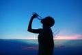 Silhouette of woman Rehydrate and refresh at sunset Royalty Free Stock Photo