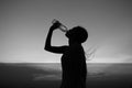 Silhouette of woman Rehydrate and refresh at sunset Royalty Free Stock Photo