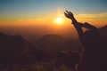 Silhouette woman rising hands on mountain in morning with vintage light,North Thailand Royalty Free Stock Photo