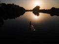 silhouette of woman in river on sunset Royalty Free Stock Photo