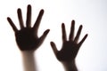 The silhouette of a woman`s hand expressing fear.