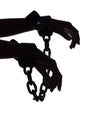 Silhouette of woman's hands with chains