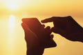 Silhouette of woman`s hands holding mobile phone Royalty Free Stock Photo