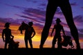 Silhouette of woman's legs and three cowboys in the sunset