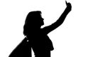 Silhouette of a woman with shopping bags doing selfie Royalty Free Stock Photo