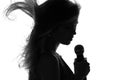 Silhouette of a woman singing with a microphone in hands Royalty Free Stock Photo