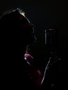 Silhouette of woman singing.