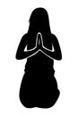 Silhouette of a Woman sitting on her knees praying