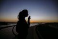 Silhouette of a woman smelling flower Royalty Free Stock Photo