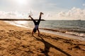 Silhouette woman somersault and exercise on the beach sunset.