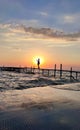 Silhouette of woman standing on sea pier against sunset Royalty Free Stock Photo