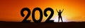 2021, silhouette of a woman standing in the sunset, women empowerment feminist new year holiday panoramic web banner