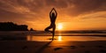 Silhouette of woman standing at yoga pose on the tropical beach during sunset. Girl practicing yoga near sea water Royalty Free Stock Photo