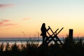 Silhouette of a woman on a stile at twilight time Royalty Free Stock Photo