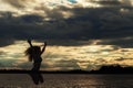 Silhouette woman at sunset jump on the beach Royalty Free Stock Photo