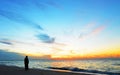 Silhouette woman,sunset on ocean Amity Point beach, North Stradbroke Island,Australia