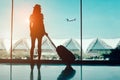 Silhouette woman travel with luggage looking without window at airport terminal international or girl teenager traveling in vacati Royalty Free Stock Photo