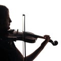 Silhouette of a woman violinist. Square. Close-up. Violin and bow in musical hands.