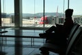 Silhouette of woman waiting for flight at the airport Royalty Free Stock Photo