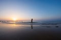 silhouette of a woman walking along the seashore. Spiritual Peace Meditation. A happy girl walks along the seashore against the Royalty Free Stock Photo