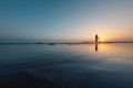 silhouette of a woman walking along the seashore. Spiritual Peace Meditation. A happy girl walks along the seashore against the Royalty Free Stock Photo