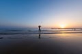 silhouette of a woman walking along the seashore. Spiritual Peace Meditation. A happy girl walks along the seashore against the Royalty Free Stock Photo