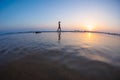 silhouette of a woman walking along the seashore. Spiritual Peace Meditation. A happy girl walks along the seashore against the Royalty Free Stock Photo