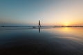 silhouette of a woman walking along the seashore. Spiritual Peace Meditation. A happy girl walks along the seashore against the Royalty Free Stock Photo