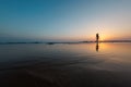 silhouette of a woman walking along the seashore. Spiritual Peace Meditation. A happy girl walks along the seashore against the Royalty Free Stock Photo