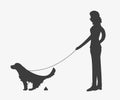 Silhouette of woman walking a dog om leash.