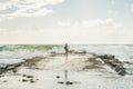 Silhouette of woman walking on pier at stormy Mediterranean sea Royalty Free Stock Photo