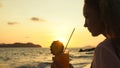 Silhouette woman walks on sunset on beach against background of Royalty Free Stock Photo