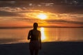 Silhouette of woman watching stunning sunrise of lake Bonneville Salt Flats, Wendover, Western Utah, USA, America. Dreamy red Royalty Free Stock Photo