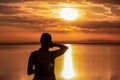 Silhouette of woman watching stunning sunrise of lake Bonneville Salt Flats, Wendover, Western Utah, USA, America. Dreamy red Royalty Free Stock Photo