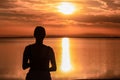 Silhouette of woman watching stunning sunrise of lake Bonneville Salt Flats, Wendover, Western Utah, USA, America. Dreamy red Royalty Free Stock Photo