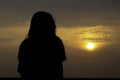 Silhouette of a woman watching the sunrise in the morning Royalty Free Stock Photo