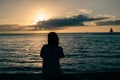 Silhouette of woman watching sunset over the sea Royalty Free Stock Photo