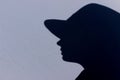 Silhouette of woman wearing a hat, close up. Abstract people concept.