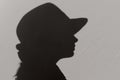 Silhouette of woman wearing a hat, close up. Abstract people concept.